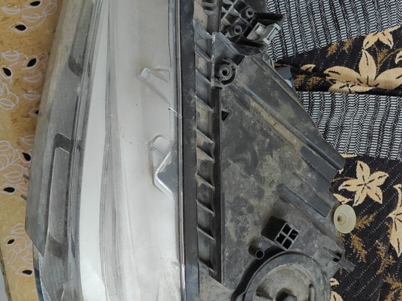 Used BMW 320d front headlight assembly with broken glass