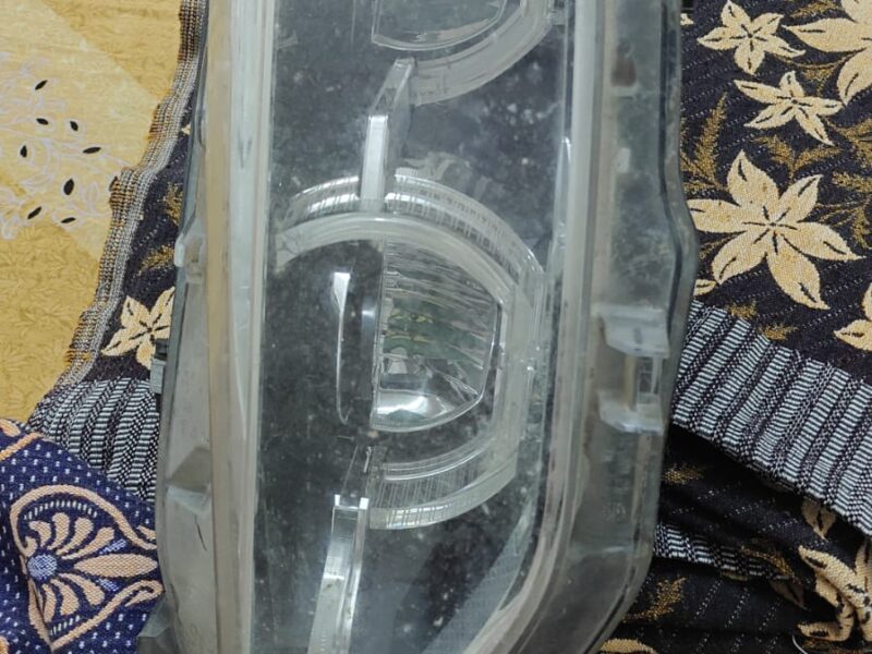 Used BMW 320d front headlight assembly with broken glass