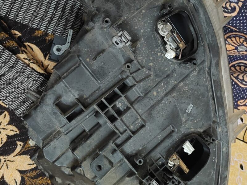 Used BMW 320d front headlight assembly with broken glass