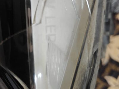 Used BMW 320d front headlight assembly with broken glass